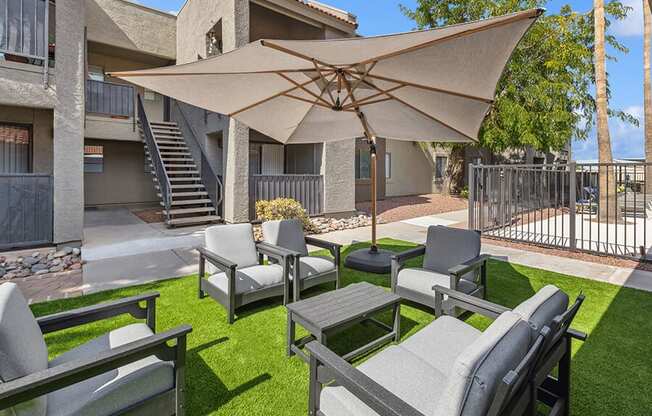 Outdoor Lounge Area with Covered Furniture at Saddle Ridge Apartments in Tucson, AZ.