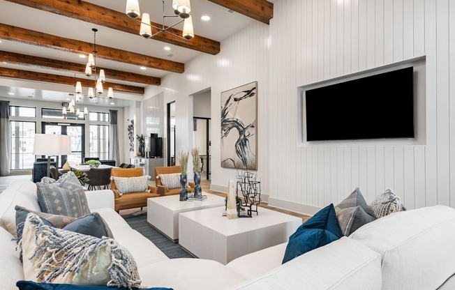 a living room with a white couch and a tv