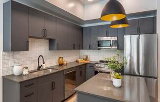 Kitchen with Dark Accents at Maye House Apartments