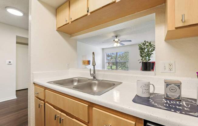 A kitchen with wooden cabinets and a white countertop.