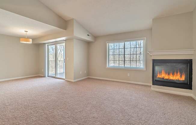 an empty living room with a fireplace