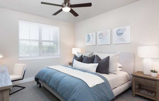 a bedroom with a large bed and a ceiling fan