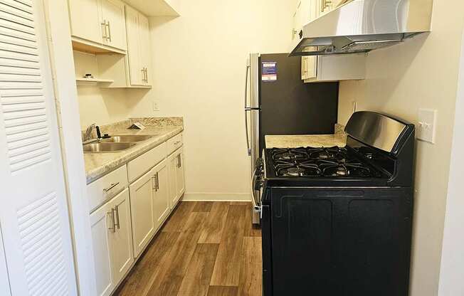 A kitchen with stainless steel appliances and white cabinetry at Waverly Park Apartments, Lansing