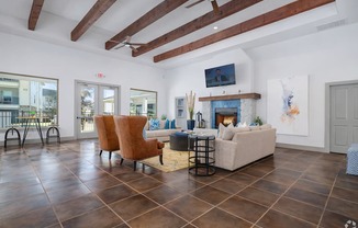 A living room with a fireplace and a TV mounted on the wall.