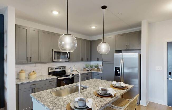 a kitchen with stainless steel appliances and granite counter tops