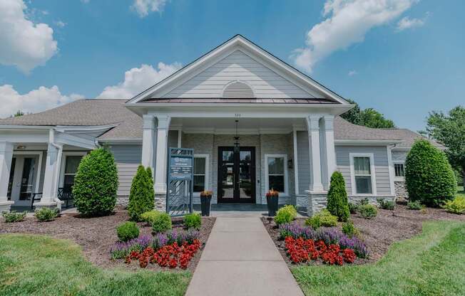 A house with a front yard and a walkway leading to the front door.