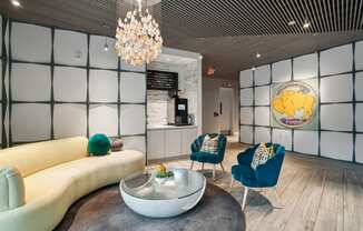 a living room with a couch and chairs and a coffee table at Link Apartments® Mint Street, Charlotte, NC, 28203