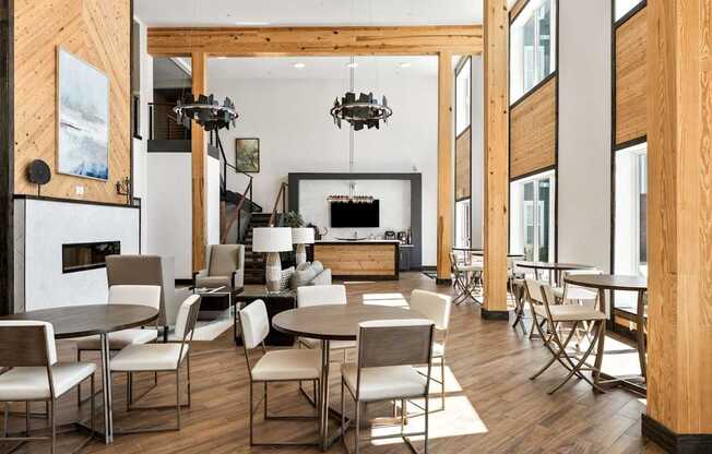 A modern dining room with a fireplace and a large painting on the wall.