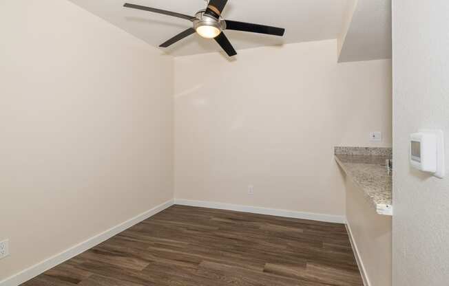 One Bedroom Dining Room with a ceiling fan and bar style counter top at Rocklin Manor  Apartments, California