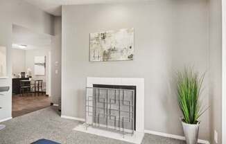 A living room with a fireplace and a painting on the wall.