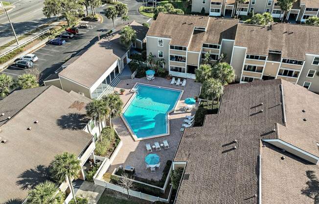 an aerial view of the resort style swimming pool in the middle of the buildings