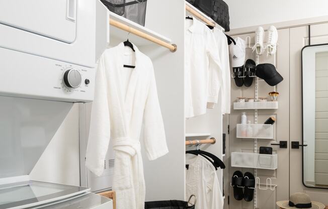 a small bathroom with a white wardrobe and a black and white rug