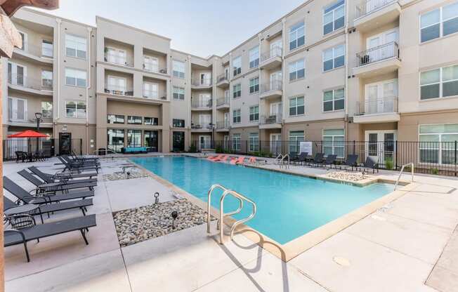 Swimming Pool Area With Shaded Chairs at Residences at 3000 Bardin Road, Grand Prairie, TX, Texas