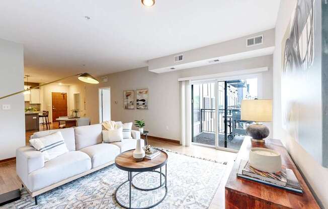 A living room with a white sofa and a coffee table.