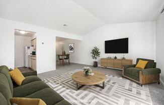 a living room with a cathedral ceiling, couch and a coffee table at Hampton Lakes Apartments, Michigan, 49534