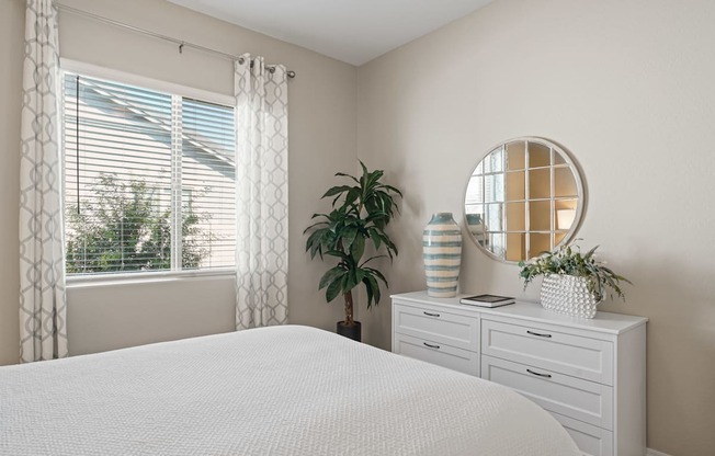 a bedroom with a large white bed and a window