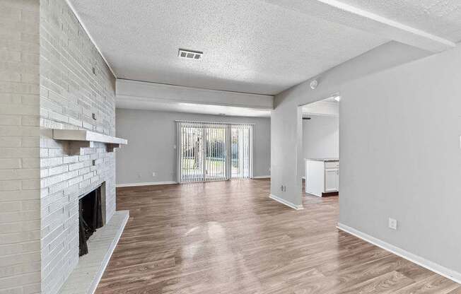 Pet-Friendly Apartments in Overland Park, KS - Treetop Lodge - Photo of Luxury Renovated Living Room with Wood style flooring and fireplace