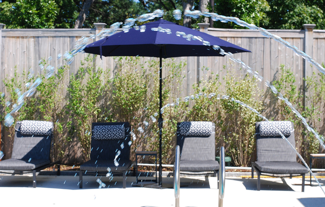 Pool-Side Deck Featuring Lounge Chairs and Shade Umbrellas