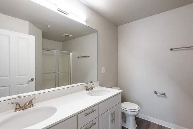 a bathroom with two sinks and a toilet