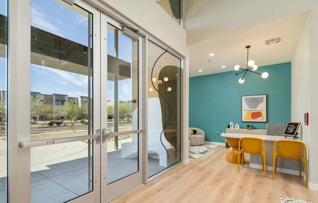 A room with a blue wall and a table with chairs.