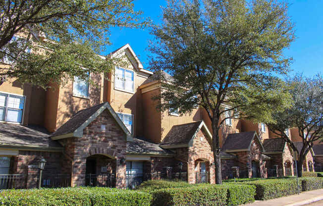 This is a photo of some Townhome exteriors at The Brownstones Townhome Apartments in Dallas, TX.