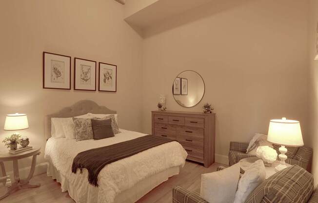 a bedroom with a bed and a chair and a mirror