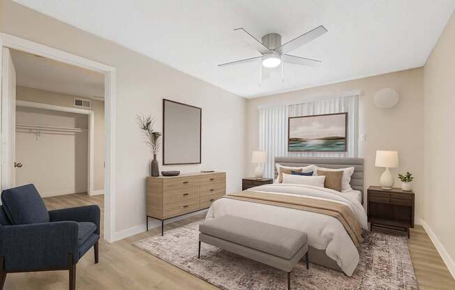 A bedroom with a bed, nightstand, and chair.