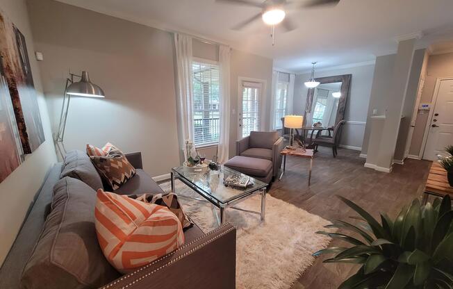 a living room filled with furniture and a large window