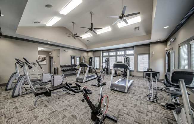 a gym with treadmills and other exercise equipment at the enclave at university crossings