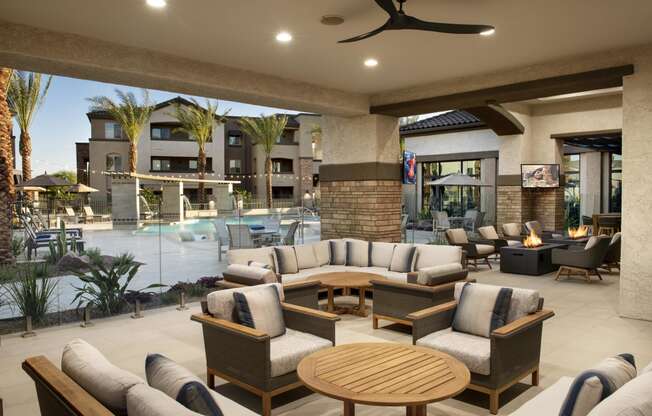 a lobby with couches and tables and a swimming pool