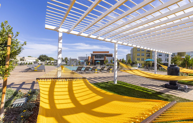 a group of yellow hammocks under a white shad at Solasta, Sacramento, CA, 95831