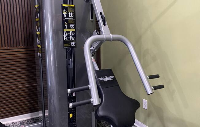 a gym with a exercise machine in the corner of a room