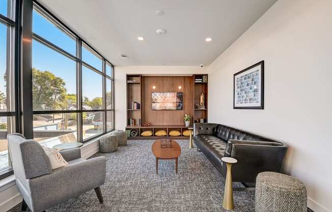a living room with couches chairs and a coffee table in front of a large window