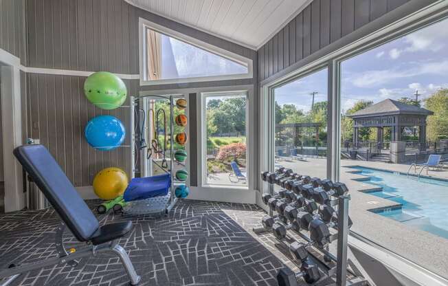 a home gym with a view of a swimming pool and glass doors  at Butternut Ridge, Ohio, 44070