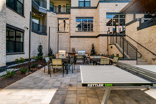 a ping pong table in the courtyard of an apartment building