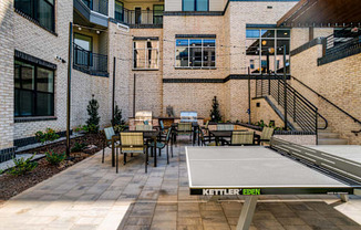 a ping pong table in the courtyard of an apartment building