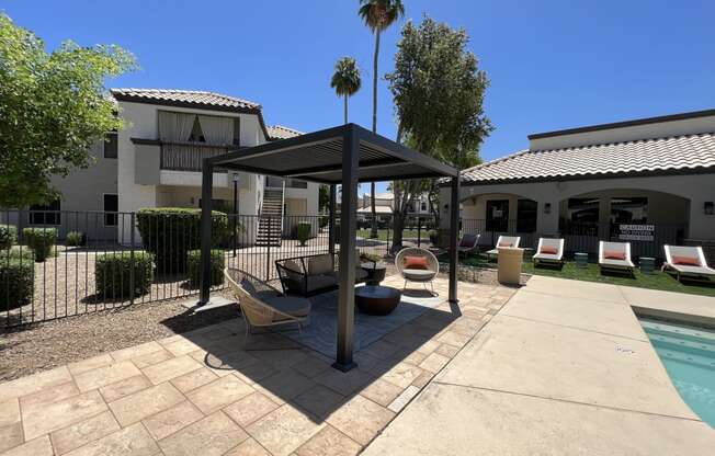 Relax on our patio by the pool, right outside our building at Boulders at Lookout Mountain Apartment Homes, Phoenix Arizona