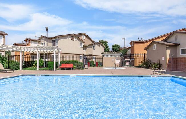 a house with a pool in front of a building