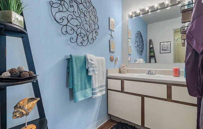 a bathroom with blue and white walls and a toilet and a sink