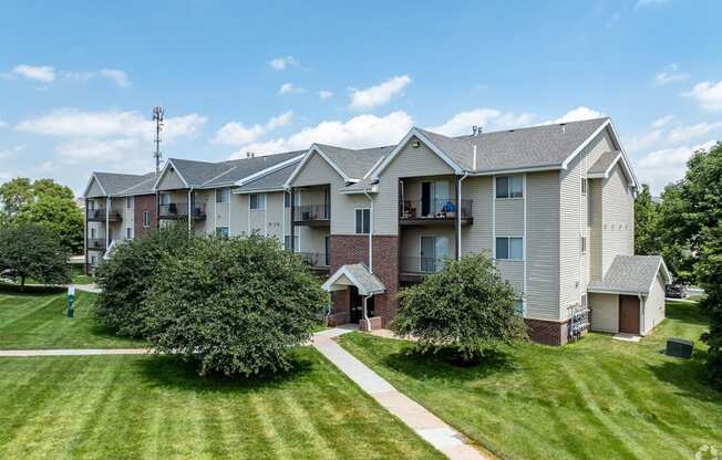 an apartment building with lawns and trees