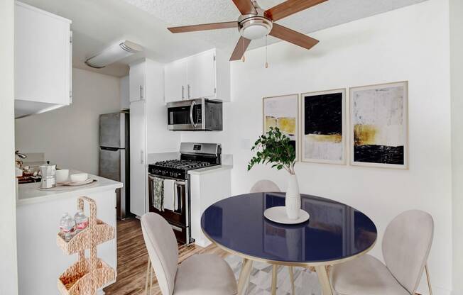 an open kitchen and dining room with a blue table and chairs