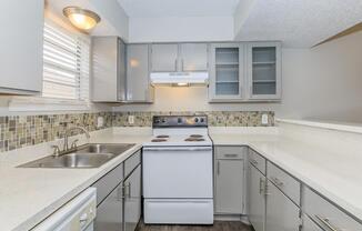 a kitchen with a stove and a sink
