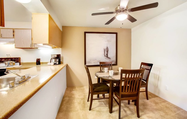 a dining room and kitchen with a table and chairs