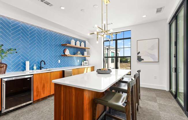 A kitchen with a blue tile backsplash and wooden cabinets.