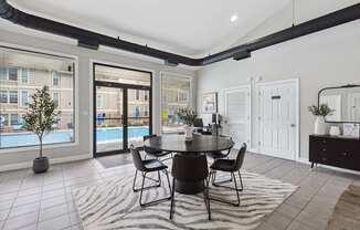 A dining room with a table set for four.
