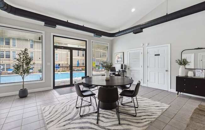 A dining room with a table set for four.