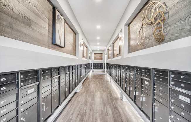 A long hallway with a series of drawers on the side and a wooden floor.