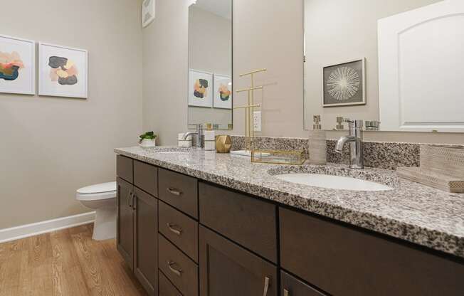 a bathroom with granite counter tops and two sinks