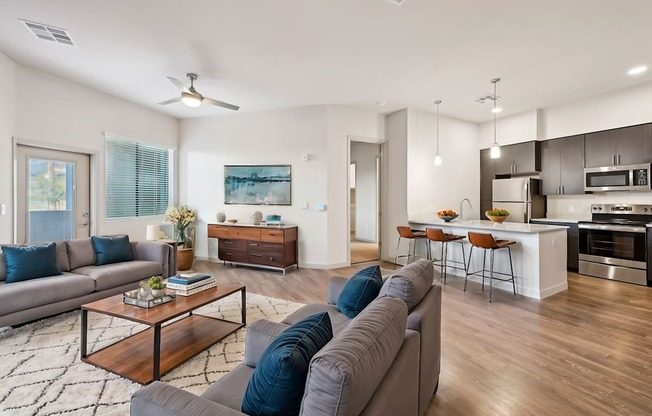 A modern living room with a grey sofa and a wooden coffee table.