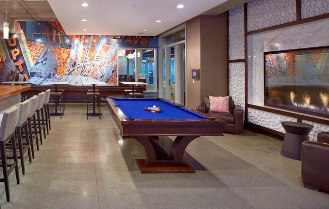 a game room with a pool table and a bar